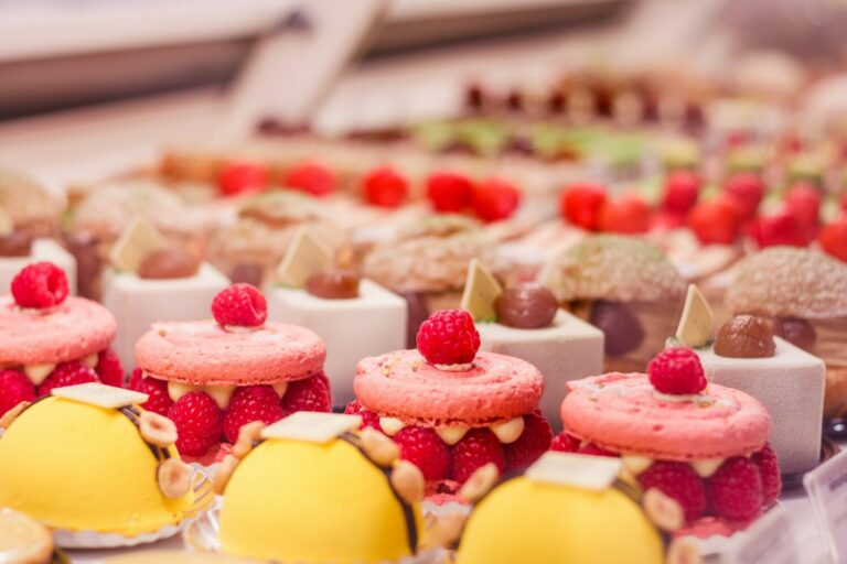 various-beautiful-delicious-pastries-on-a-showcase-in-a-french-shop--e1665052997719